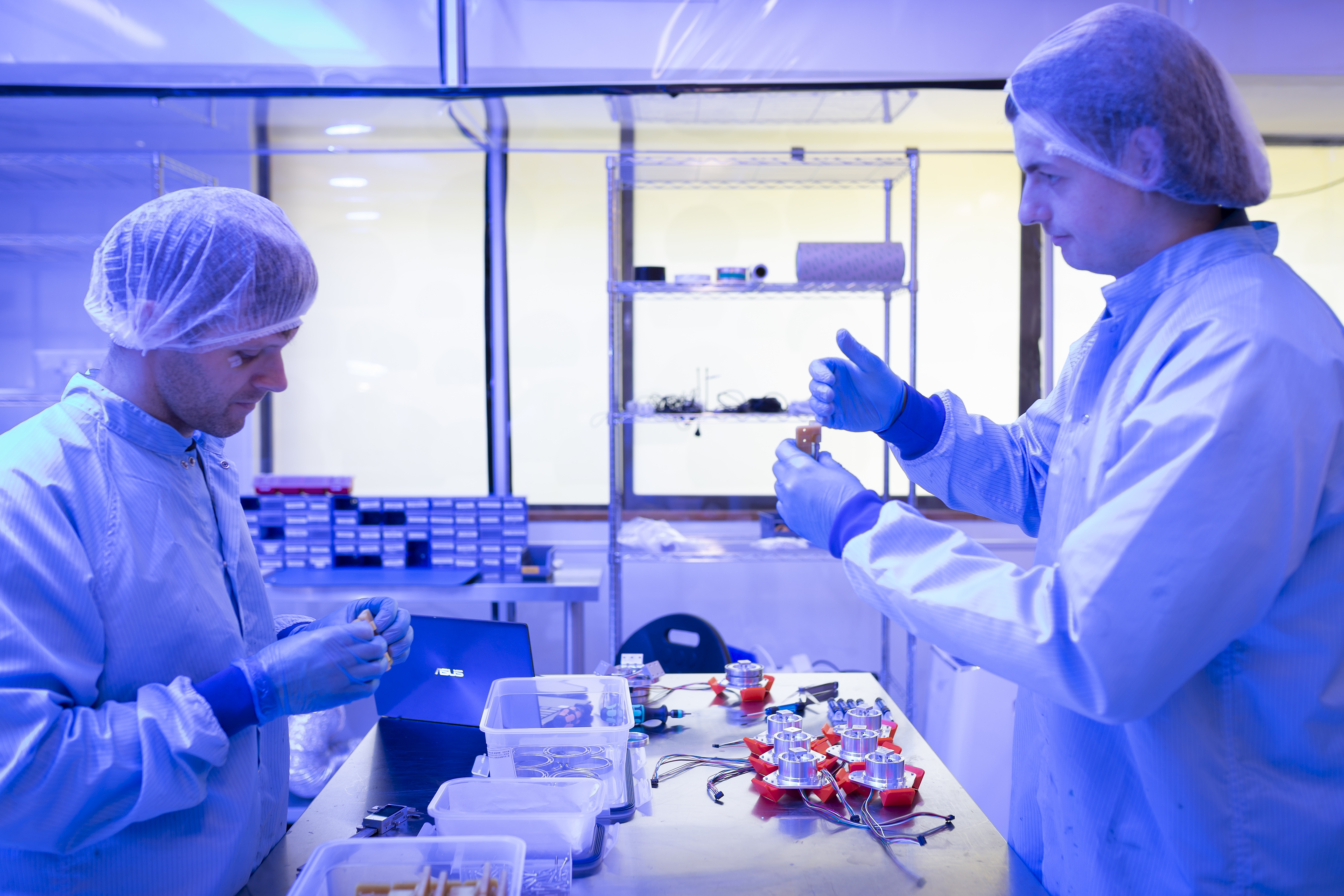 Scientists assemble electronics in sterile environment and suits.