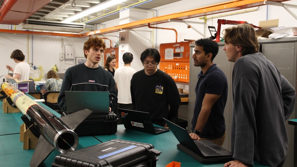 A group of students working on their high power rocket project