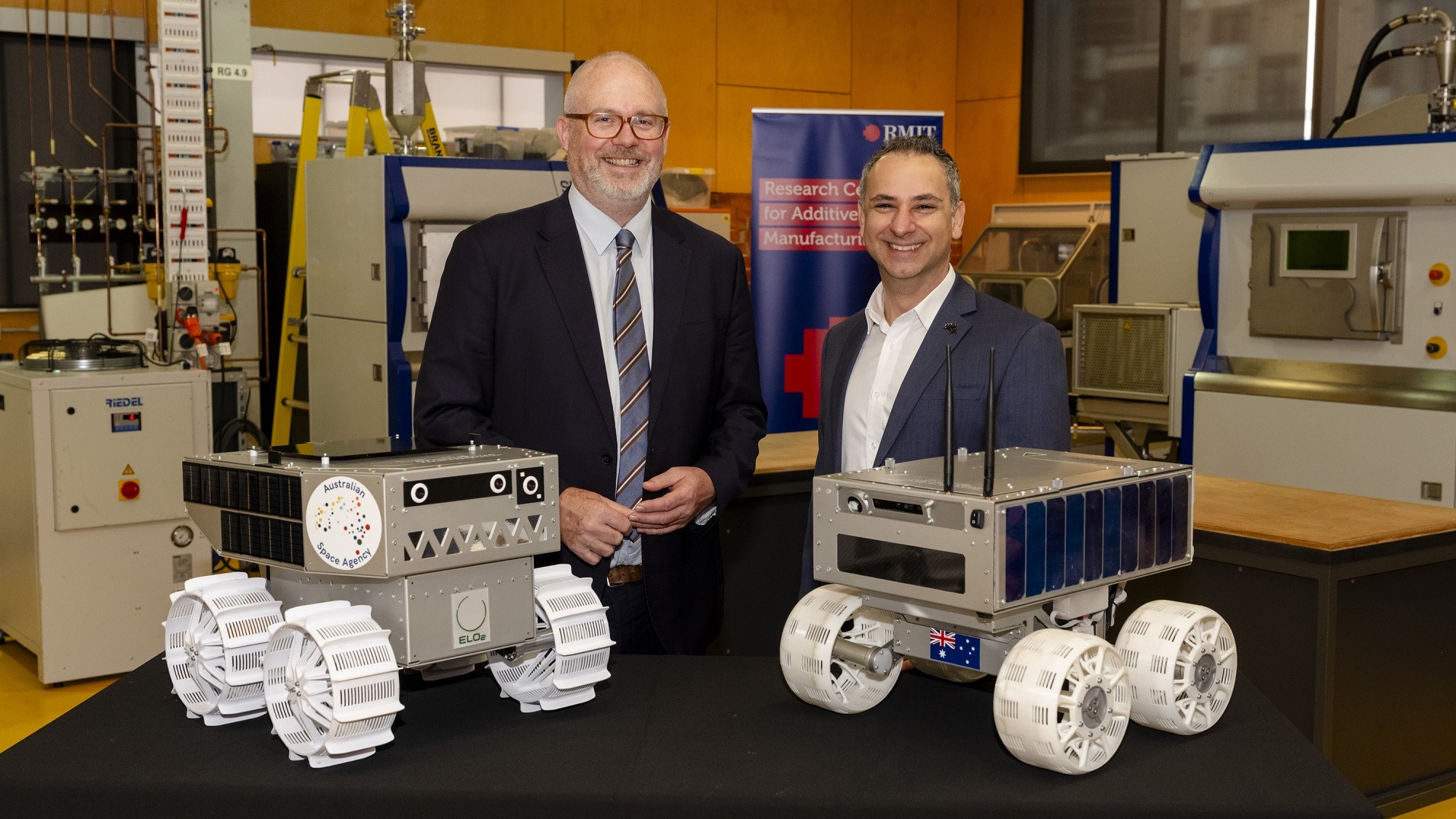 Minister for Industry and Innovation and Minister for Science Tim Ayres along with Head of the Australian Space Agency Enrico Palermo and two prototypes of Australia's lunar rover.