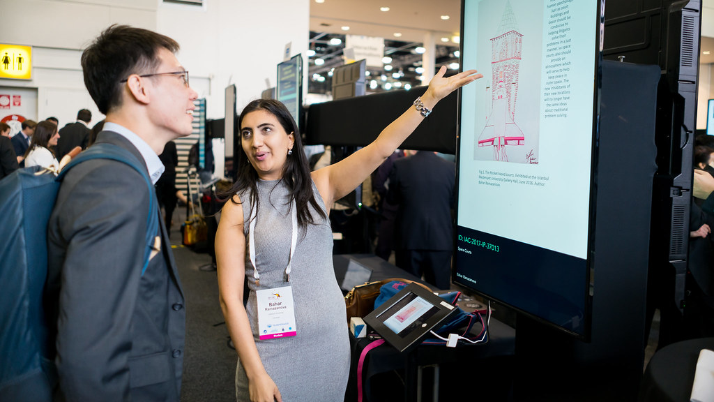 Two people discussing a space project at IAC 2017 in Adelaide, Australia