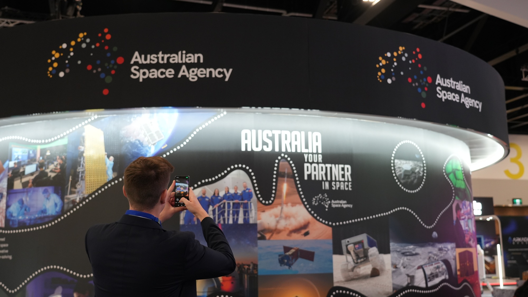 Visitors at the Australian Space Agency stand at IAC 2025