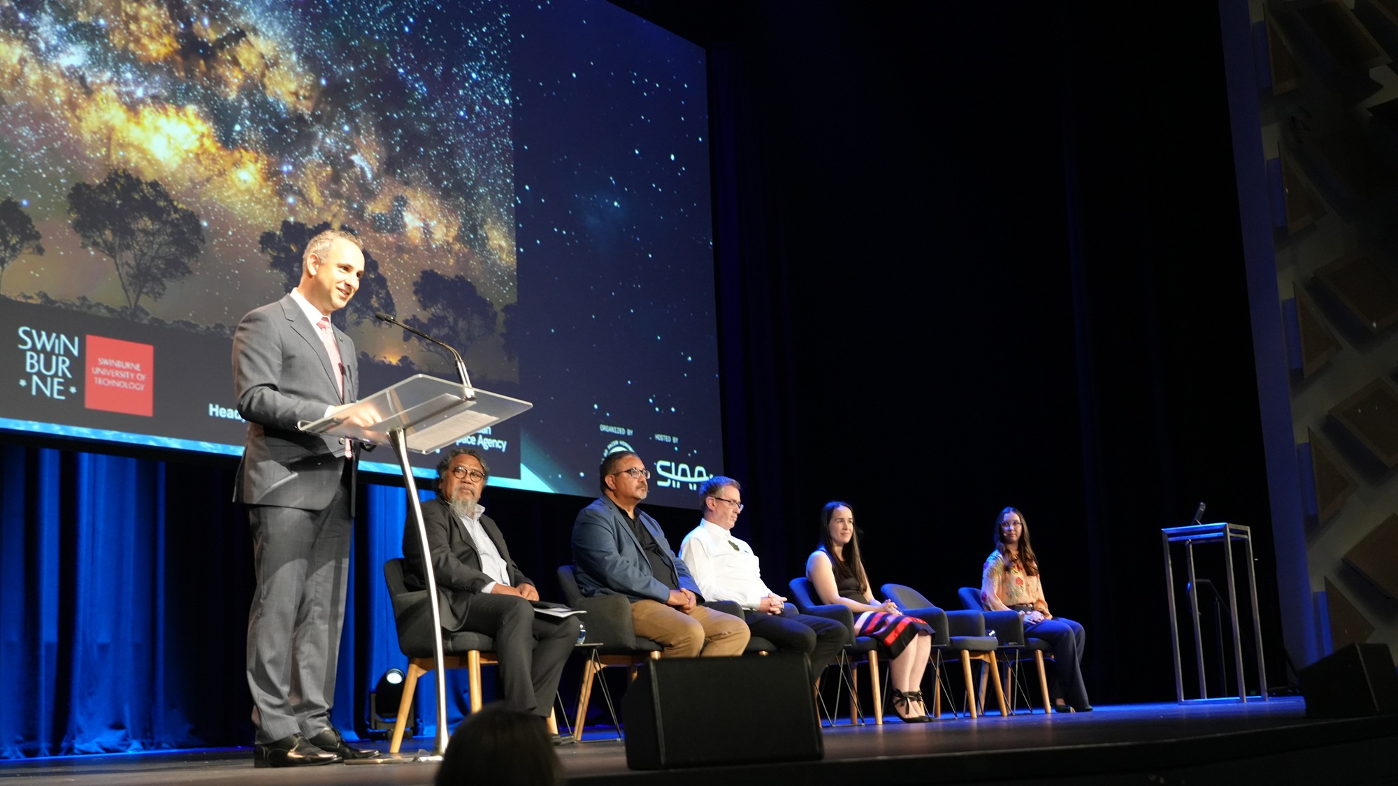 A group of people at an event at IAC 2025