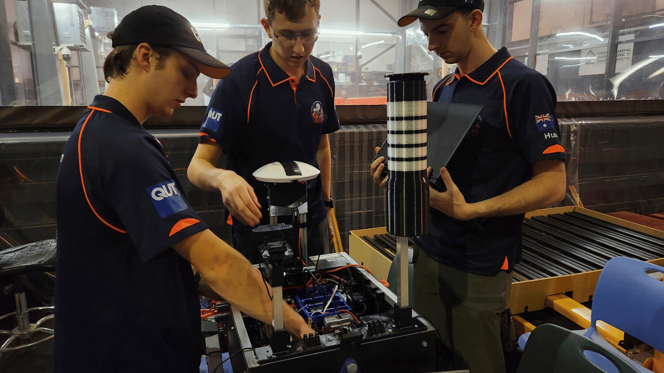 Three QUT ROAR (Remote Off-world Autonomous Robotics) team members