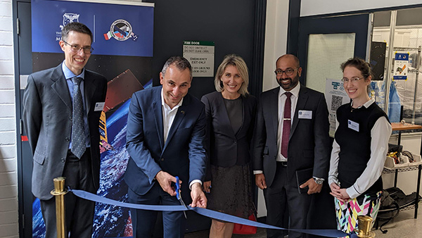 Enrico Palermo, Head of the Australian Space Agency, cutting the ribbon at the MSL opening, with Professor Michele Trenti (far left) and Professor Airlie Chapman (far right)