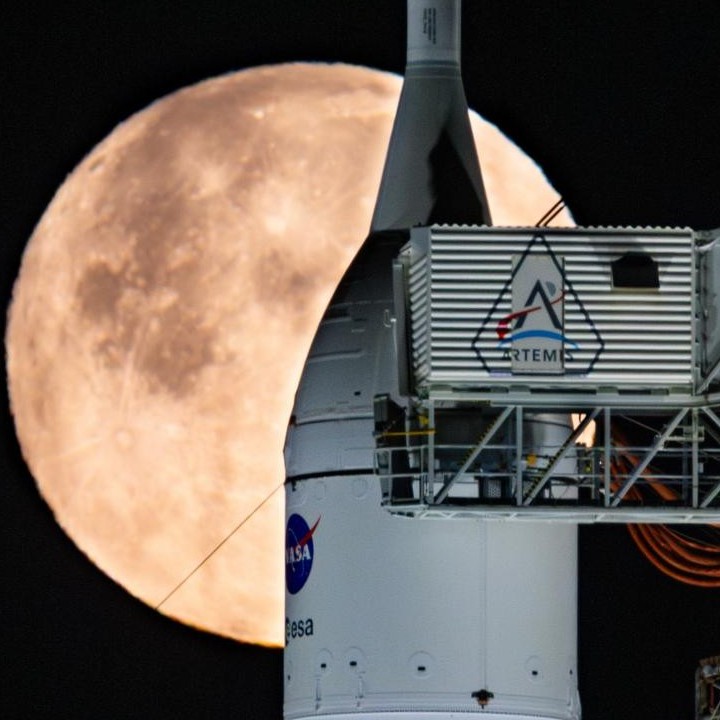 A full Moon is seen shining over NASA’s SLS (Space Launch System) and Orion spacecraft, atop the mobile launcher in the early hours of February 1, 2026. 