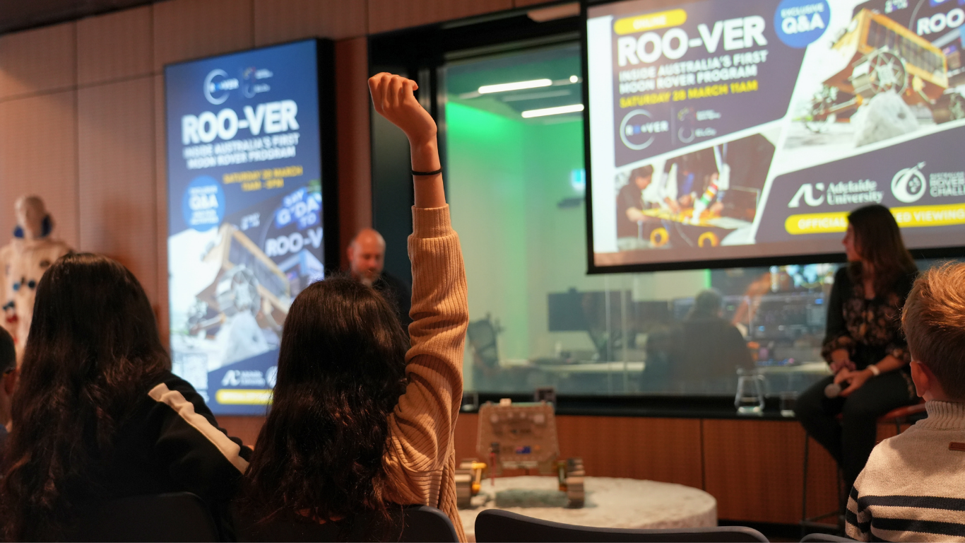 The Australian Space Agency and ELO2 hosted a special hybrid event at the Australian Space Discovery Centre on Saturday 28 March. Photos of Participants with a young space enthusiast raising their hand to ask a question.