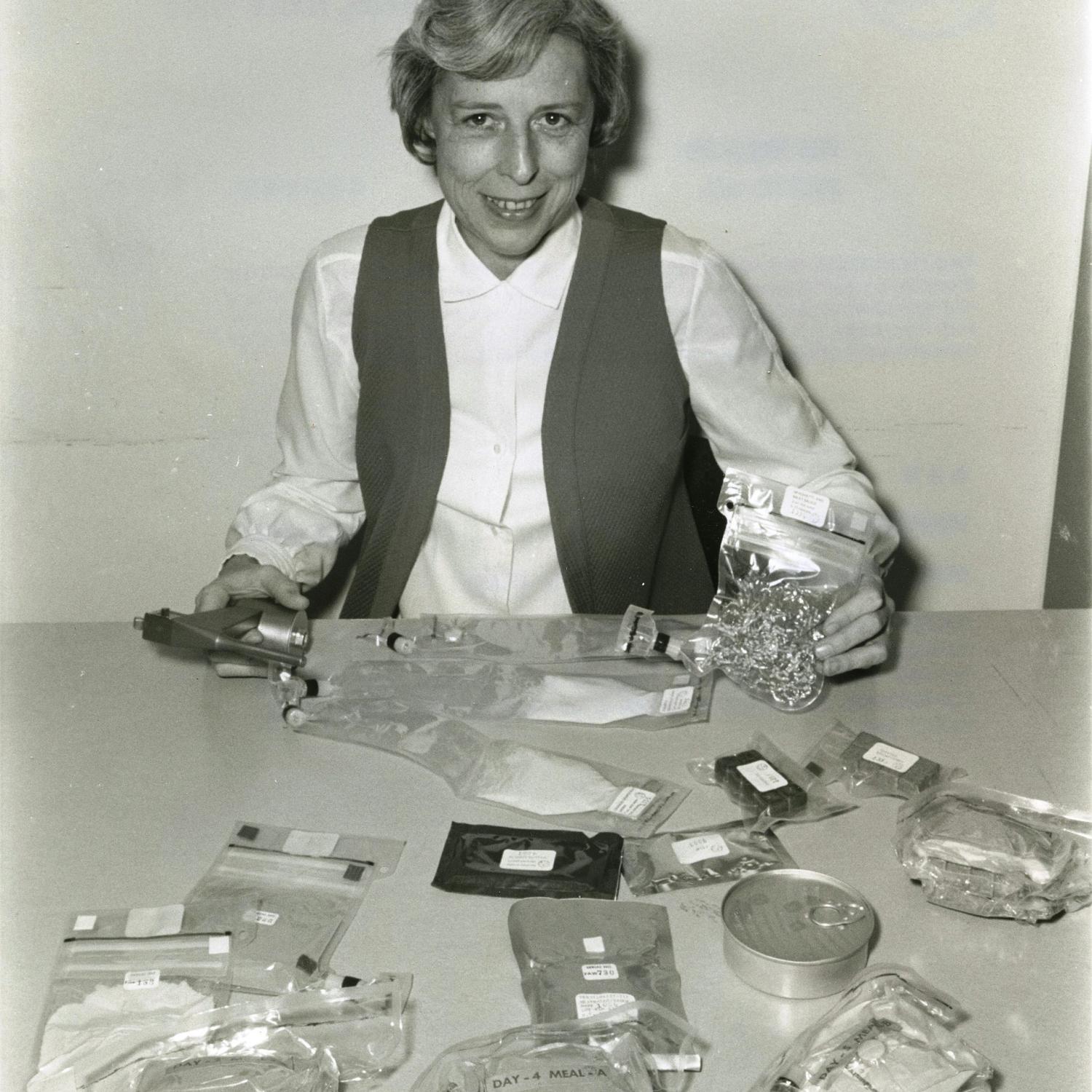 American physiologist Rita Rapp displays the range of food containers used on the Apollo 16 mission.