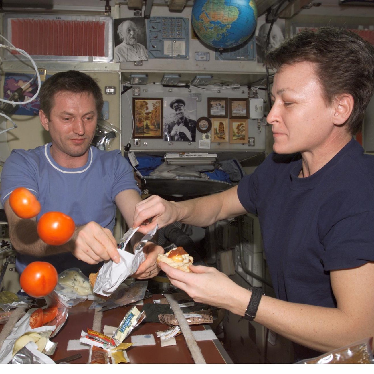 Treschev and Whitson share a meal in the SM during Expedition Five on the ISS