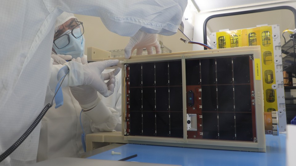 DSTG Engineer Jorge Silva-Castillo integrates the flight model spacecraft in the DSTG cleanroom facility in preparation for space qualification tests.