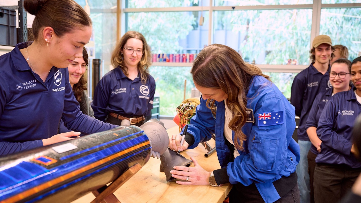 Katherine Bennell-Pegg signs the rocket nozzle, leaving her mark on the Monash High Powered Rocketry Team’s next launch