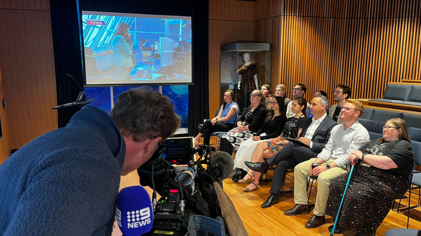 A group of space enthusiasts watching the launch of Artemis II at the Australian Space Discovery Centre