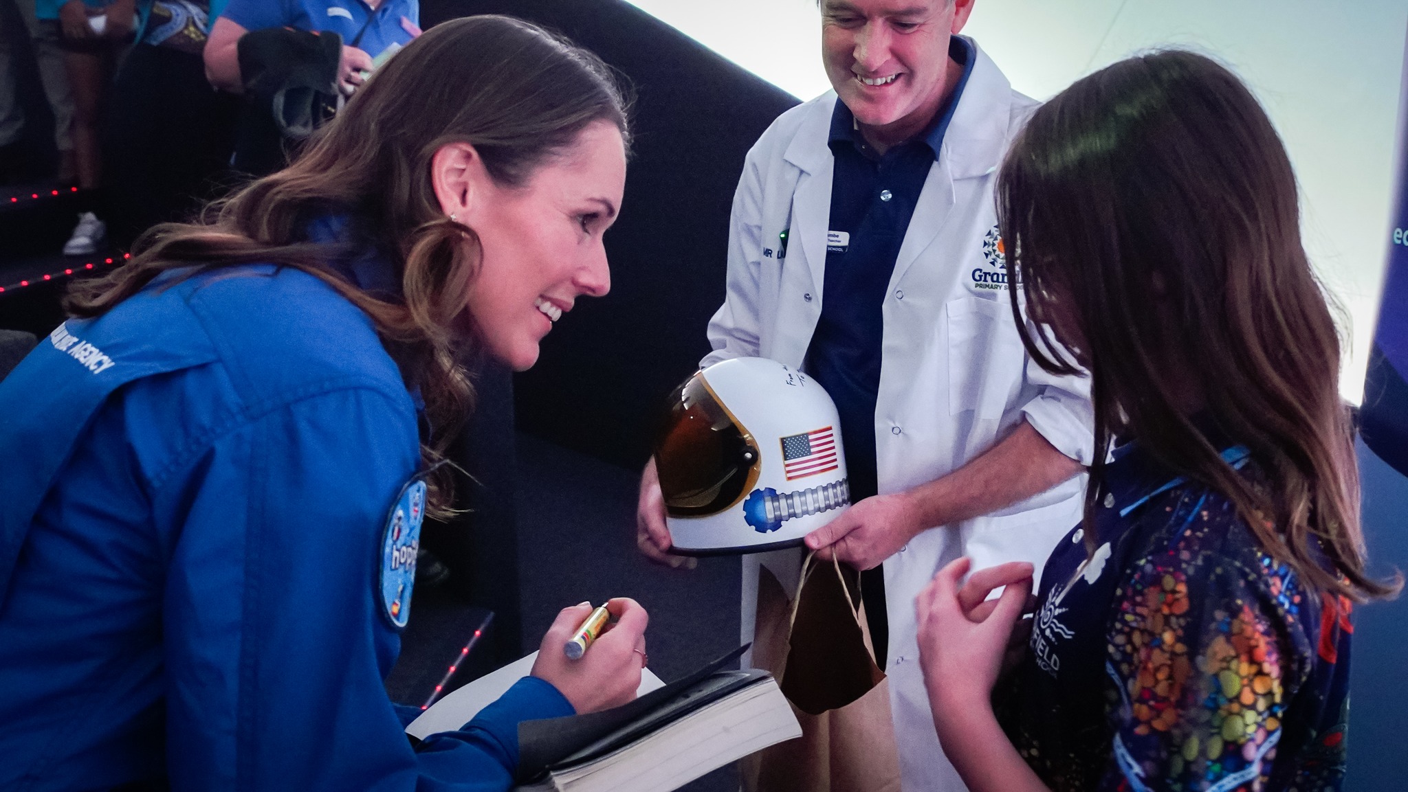 Australian astronaut Katherine Bennell-Pegg with young space enthusiasts at an event.