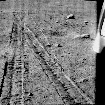 Lunokhod-1 looks back across its wheel tracks after an excursion into a crater on the Moon. 