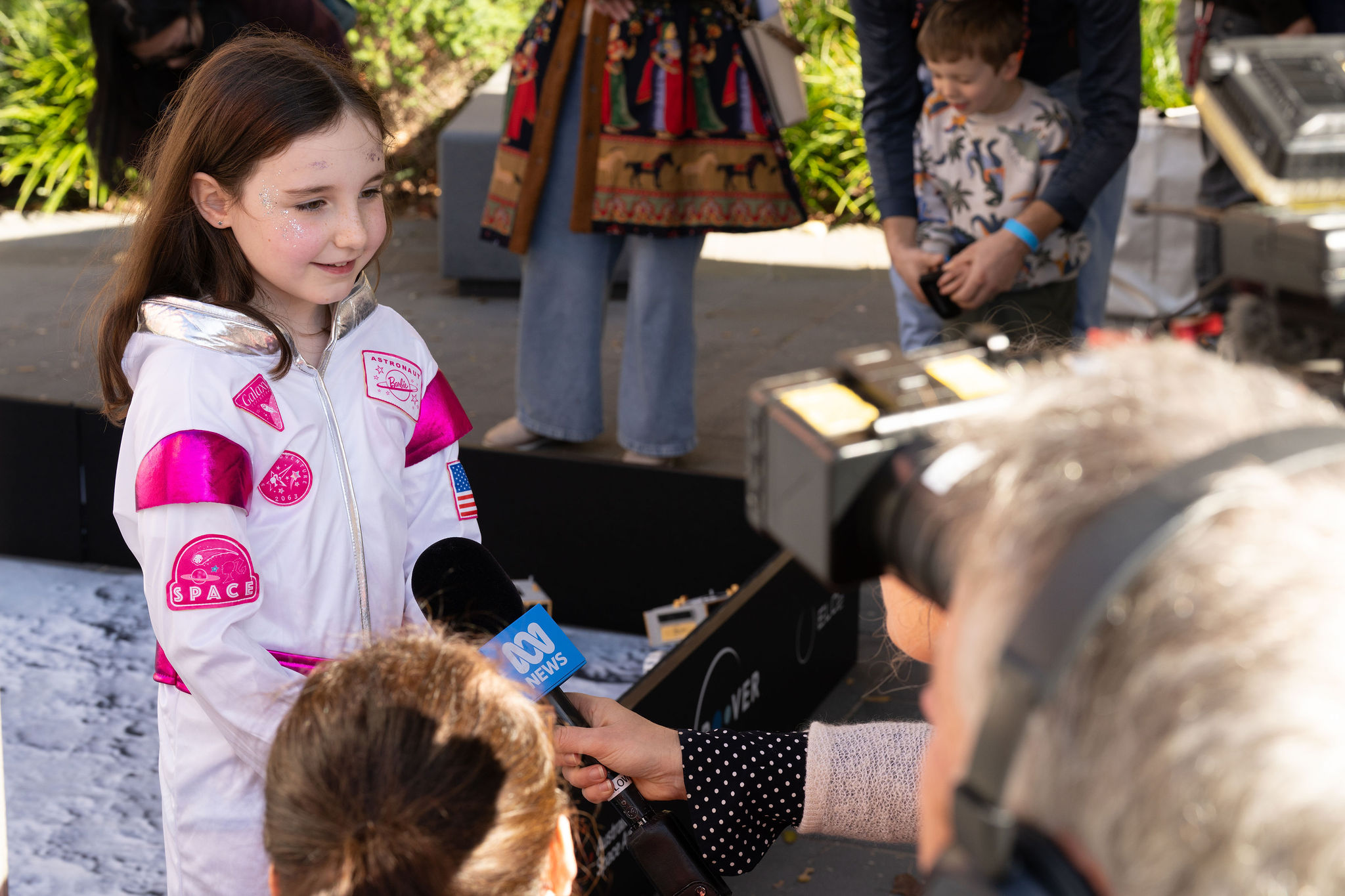 Space enthusiasts at Space Day Out 2026 at a Roo-ver activity being interviewed by the media.