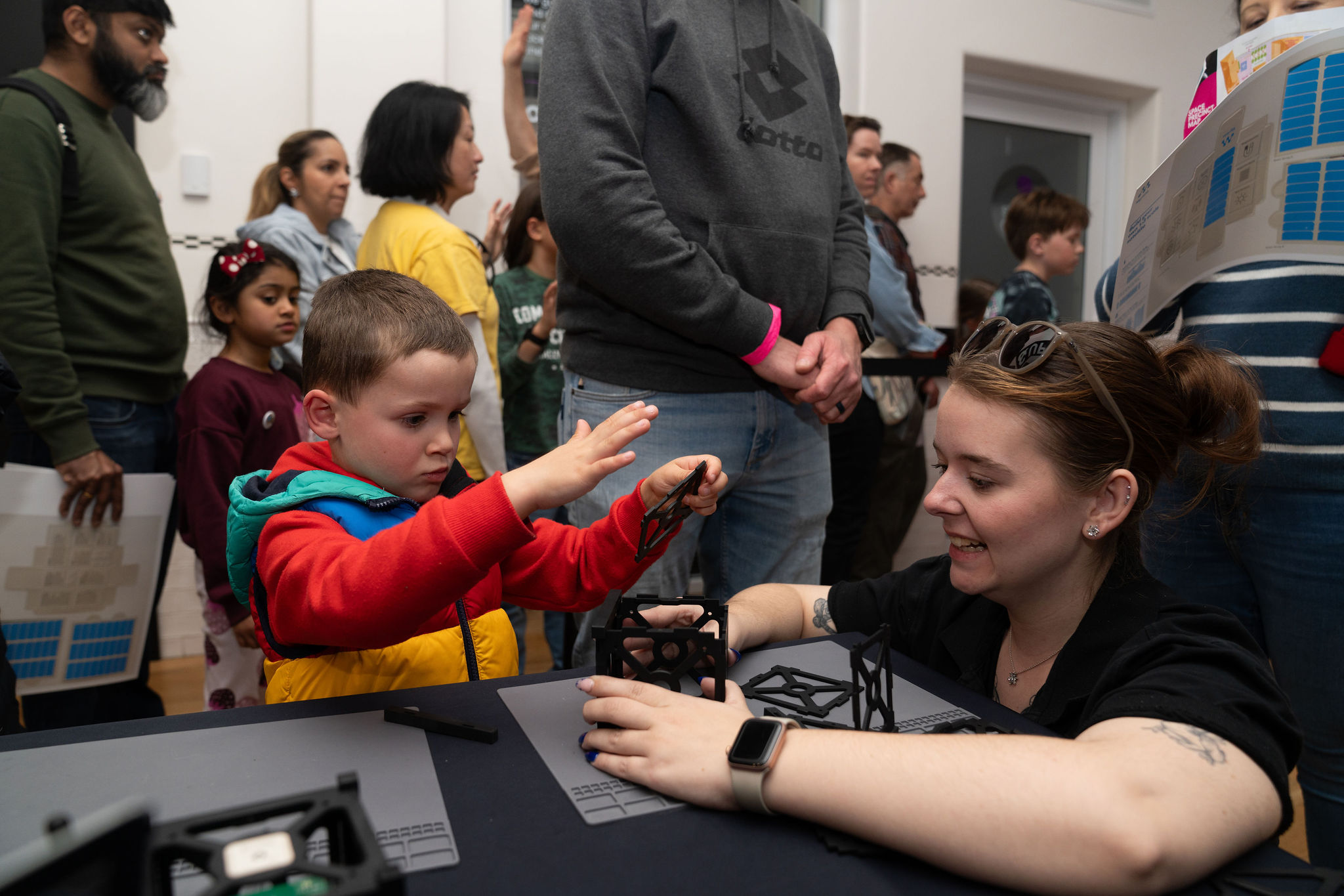 Space enthusiasts at Space Day Out 2026 seeing up close a locally built satellite.