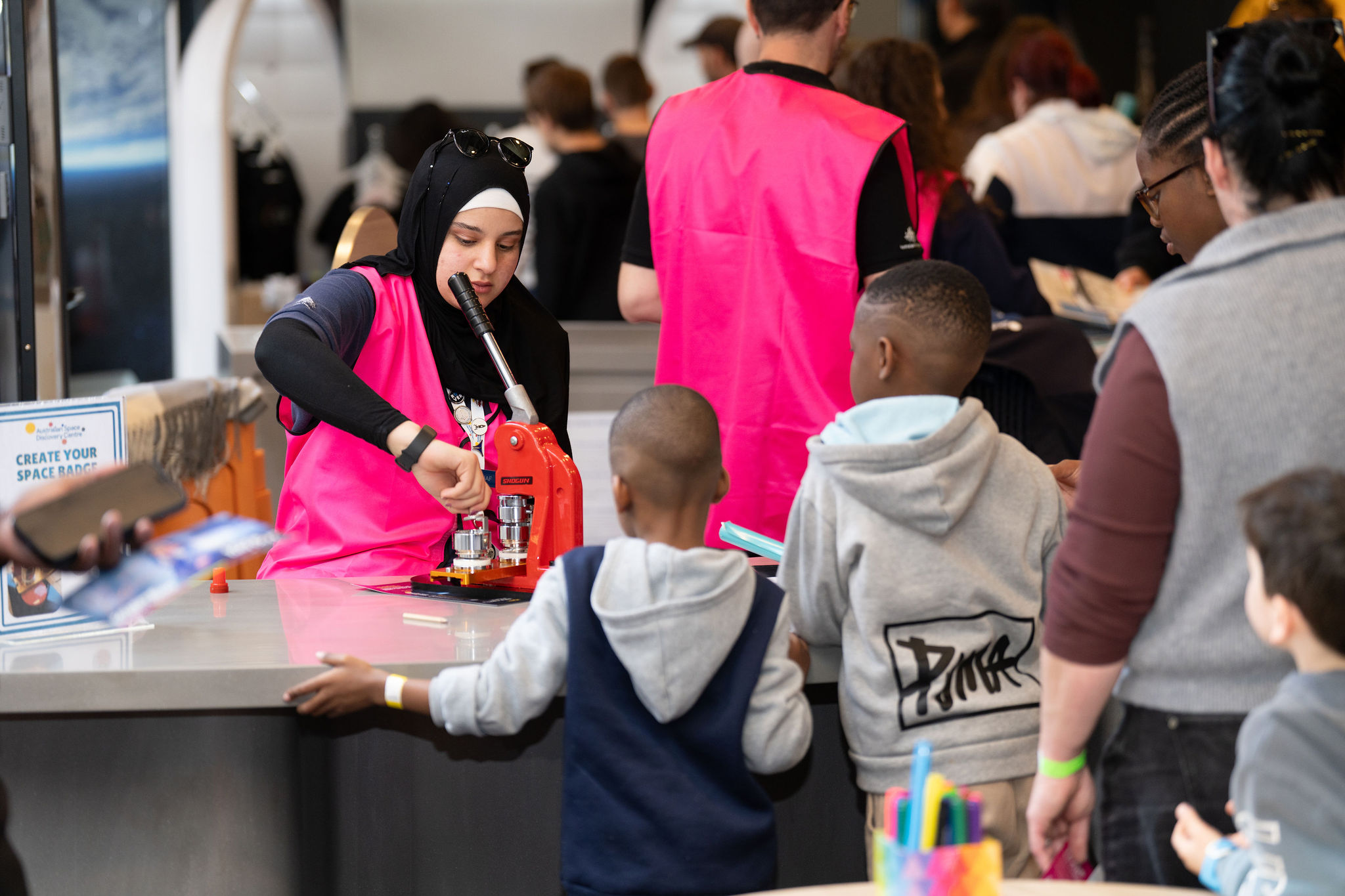 A family of space enthusiasts conducting a space activity inside the Australian Space Discovery Centre.