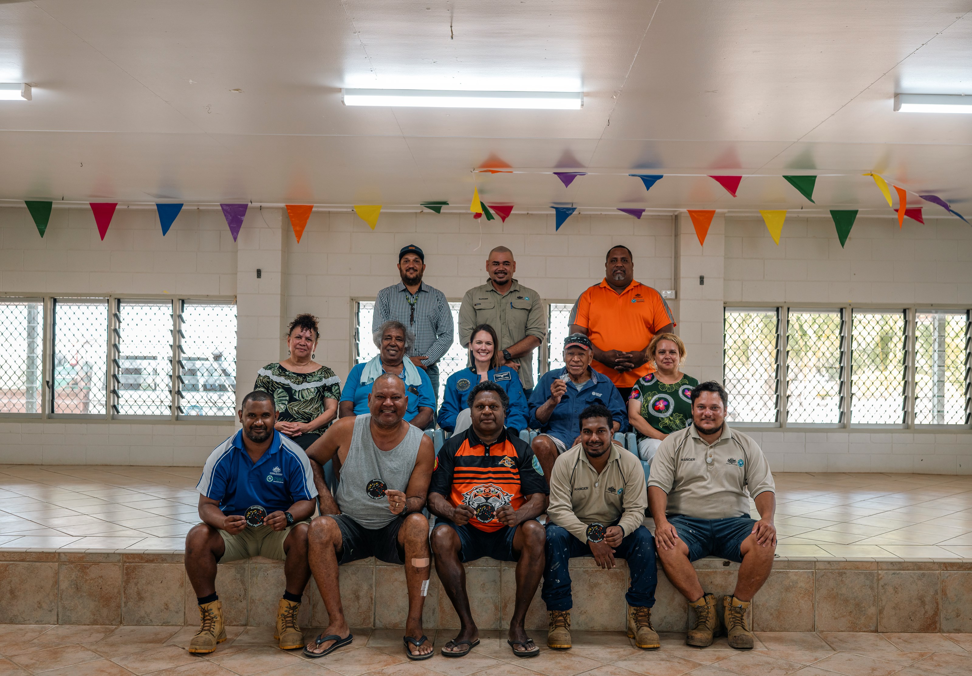 Aussie astronaut Katherine Bennell-Pegg in a group photo at a community event in the Torres Strait