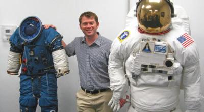 Dr James Waldie, Human Aerospace Director, with NASA Extravehicular Activity suits used for spacewalking.