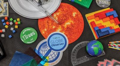 Photo of craft materials including a sticker saying I am a GLOBE observer.