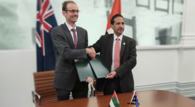 Photo of representatives of the Australian and UAE Space Agencies shaking hands in a boardroom after signing an MoU