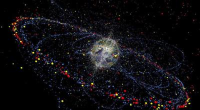 A graphic shows many pieces of space debris in orbit around the Earth.