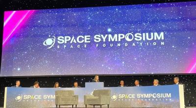 Group of speakers at a panel on a stage