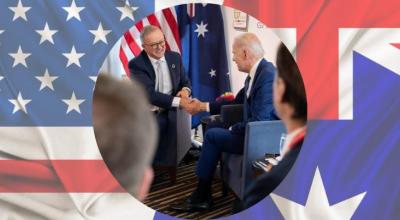 Banner of American and Australian flags behind a photo of Anthony Albanese shaking hands with Joe Biden