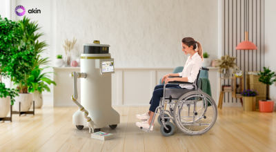 aKin's robot called 'Murphy', assisting a person at home to access a book on the floor using a robotic arm. 