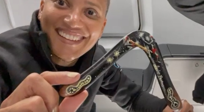 An astronaut showcasing a boomerang inside a rocket in space.