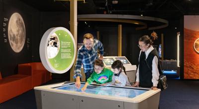 A family looking at a space exhibit.