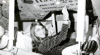 A woman working on space equipment
