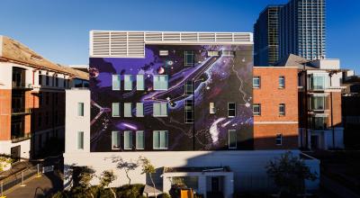 A view of a space-themed mural on a building