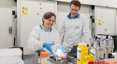two people posing for a photo in a lab