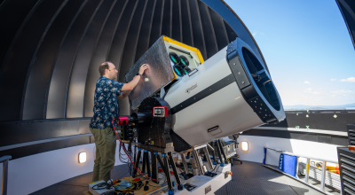 Professor Francis Bennet (pictured) with a state-of-the-art telescope at the ANU Quantum Optical Ground Station (QOGS), capable of providing space-to-ground laser communications. Photo: Nic Vevers/ANU