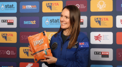 Australian astronaut and 2026 Australian of the Year Katherine Bennell-Pegg holding a Mission Sprouts kit