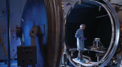 Staff working with the thermal vacuum chamber Credit: The Australian National University