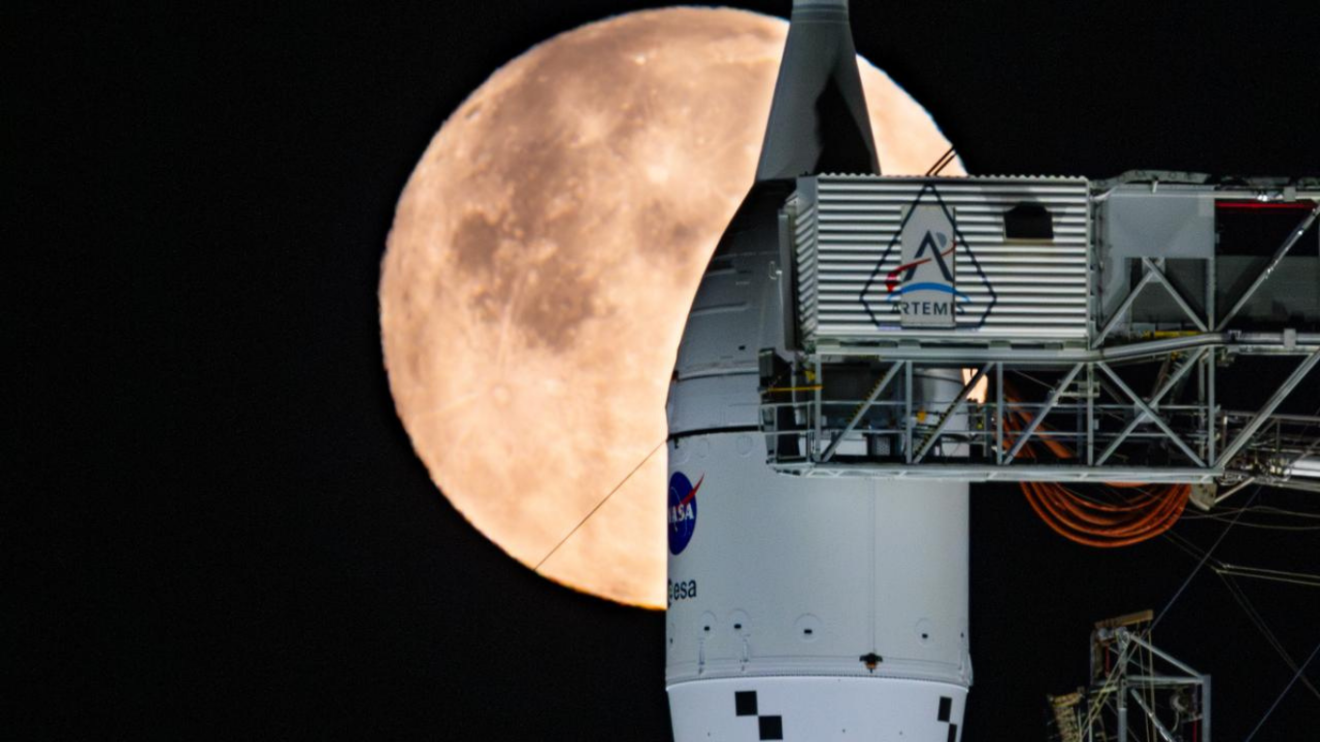 A full Moon is seen shining over NASA’s SLS (Space Launch System) and Orion spacecraft, atop the mobile launcher in the early hours of February 1, 2026. The rocket is currently at Launch Pad 39B at NASA’s Kennedy Space Center in Florida, as teams are preparing for a wet dress rehearsal to practice timelines and procedures for the launch of Artemis II. NASA/Sam Lott