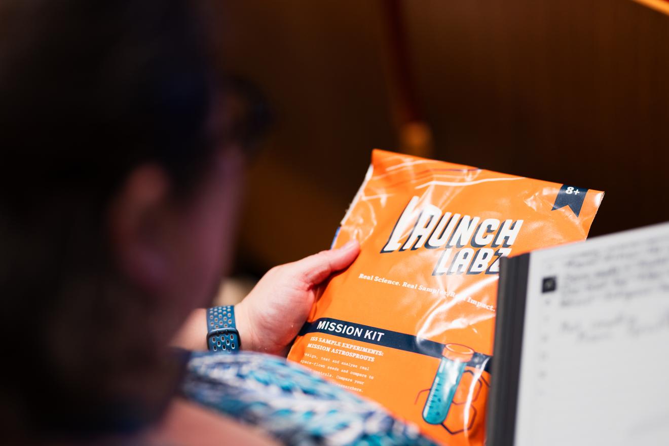 A student holding a Mission Sprouts kit