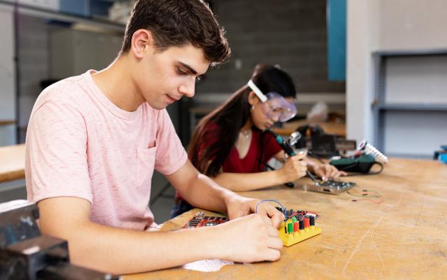 Kids test computer circuit boards