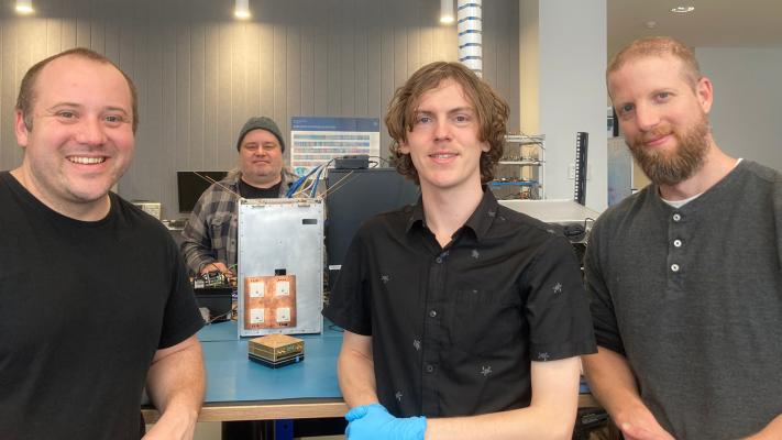 Myriota team members working on the payload