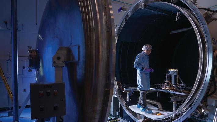 Staff working with the thermal vacuum chamber Credit: The Australian National University
